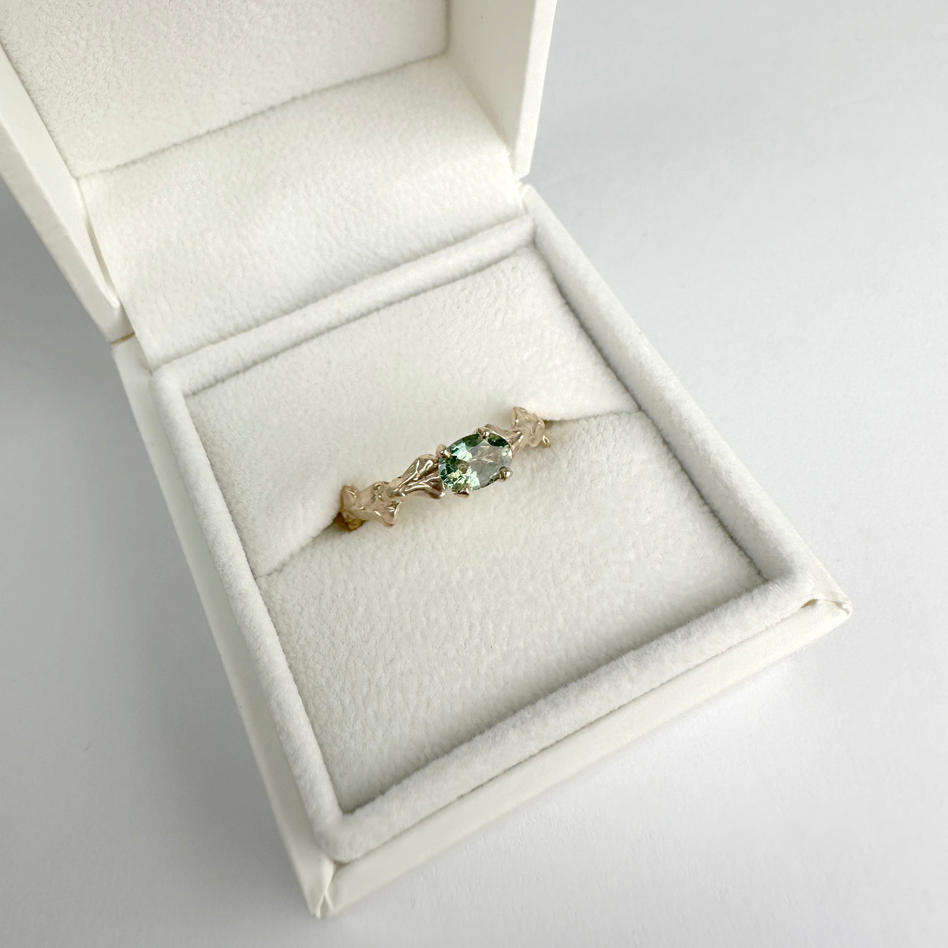 Conifer Leaf Engagement Ring in 9 carat Gold with Oval Green Sapphire