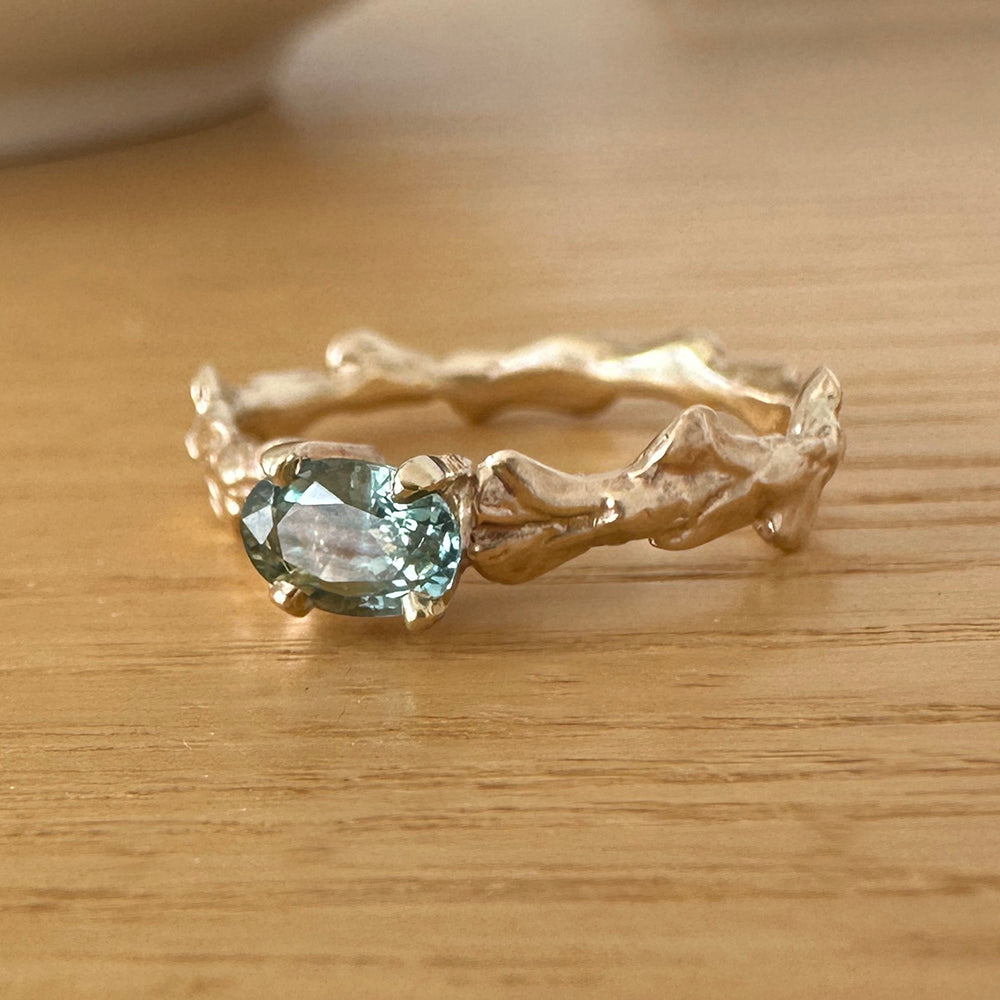 Conifer Leaf Engagement Ring in 9 carat Gold with Oval Green Sapphire