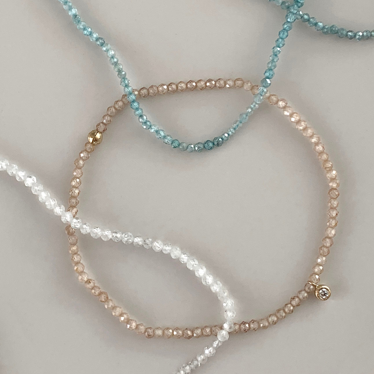 Stretch Bracelet with Blue Zircon and 9 Carat Gold Disc Charm