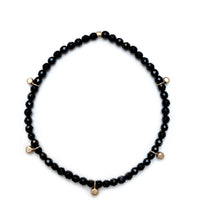 Load image into Gallery viewer, Gold bead charm stretch bracelet with black onyx faceted beads
